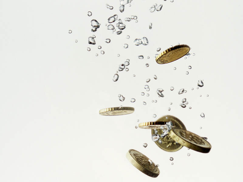 Pound coins dropped in water