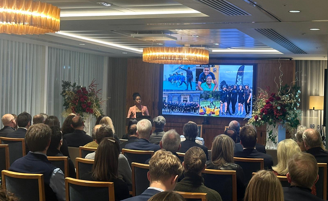 Audience members listen to a speaker