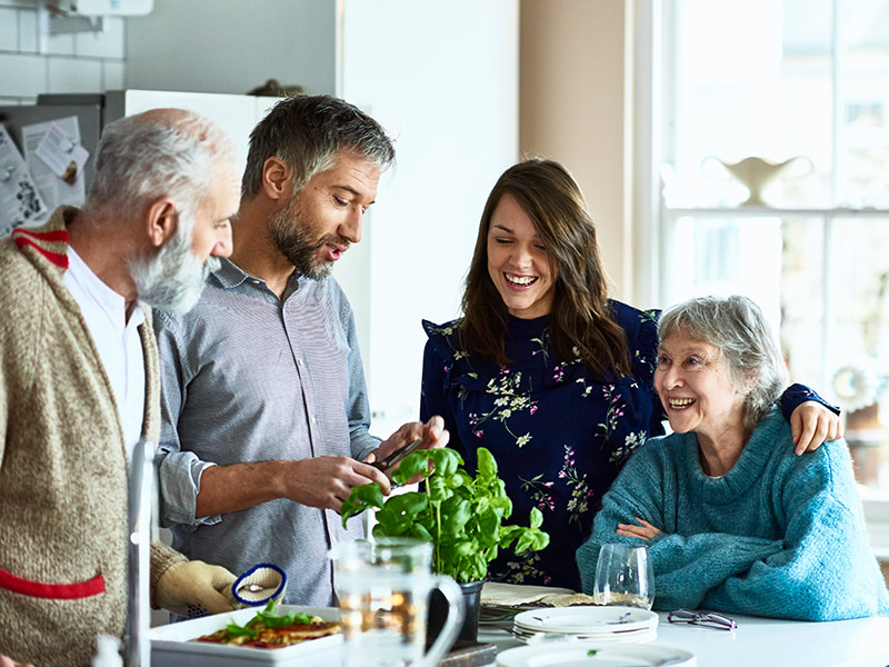 family group talking together in the kitchen space