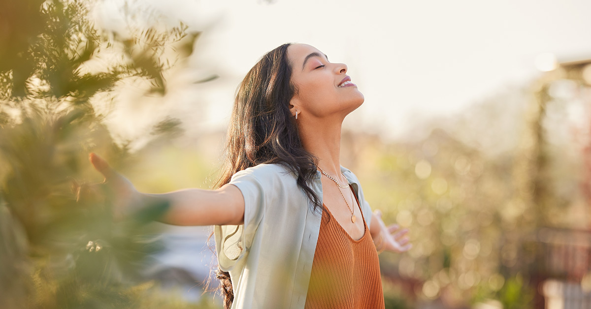Woman in a field looking content